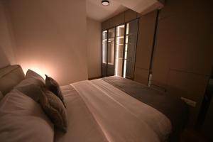 a bedroom with a bed and a window at Creamy Dreams by Dazzie in Skopje