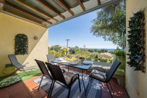 een terras met een tafel en stoelen op een balkon bij Blue Marine 1 VIP Barbati On The Beach - Public Pool in Barbati
