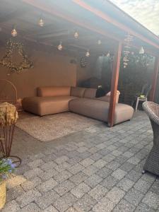 a couch sitting under a tent on a patio at Svane's Air-bnb in Nykøbing Mors