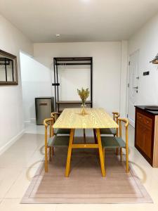 a dining room with a yellow table and chairs at Serene Escape 2 mins from SRT Wat Samien Nari in Bangkok +14 photos