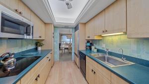 a large kitchen with a sink and a microwave at Gulf View Escape in Siesta Key