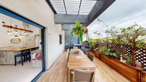 a room with a wooden table and a balcony at The Galilee Flame duplex in Shelomi