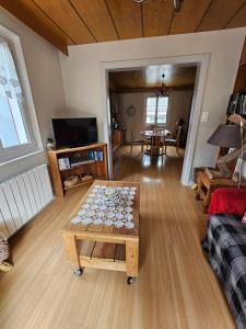 a living room with a coffee table and a couch at Le Meix du Lac 3 étoiles - 200 m du lac - 50 m navette ski in Gérardmer
