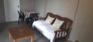 a living room with a couch and a table at Taylor's Nest in Mancana