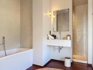 a bathroom with a sink and a tub and a mirror at Villas Inamorata in Lecci +46 photos
