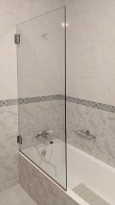 a shower with a glass door next to a bath tub at Sea and Nature Escape in Furadouro +36 photos
