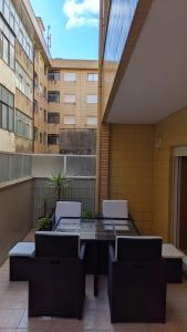 a patio with a table and chairs on a building at Sea and Nature Escape in Furadouro +36 photos