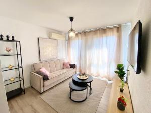 a living room with a couch and a table at Flamingo Beach Escape in Qiryat Yam
