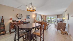 a dining room and living room with a table and chairs at Salty Soldi in Siesta Key