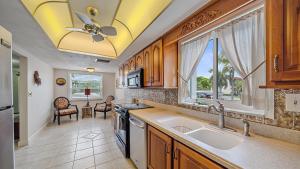 a kitchen with a sink and a ceiling fan at Salty Soldi in Siesta Key