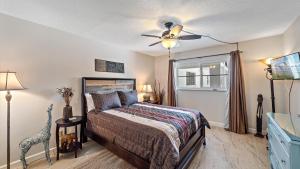 a bedroom with a bed and a ceiling fan at Salty Soldi in Siesta Key