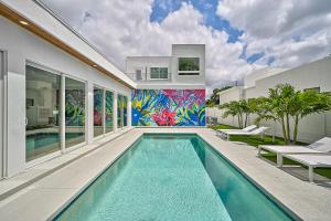 a swimming pool in a house with a mural at Paradise Found in Sarasota