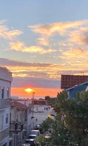 a sunset over a beach with people on the sand at Apartamento Duplex - Beach Apart in Vila Praia de Âncora