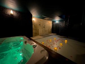 a bathroom with a tub with candles in it at Mieuxqualhotel jacuzzi privatif Velvet Desire in Bordeaux +16 photos