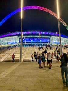 a group of people in front of a stadium at night at Lively Studio Loft 30min to Central London in London