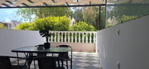 a patio with a table and chairs on a balcony at Casa Tua in Kalamata