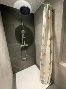 a shower with a shower head and a shower at Cosy Holliday Home for 3 persons in Voerendaal +7 photos