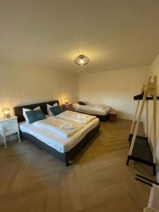 a bedroom with two beds and a ladder in it at Valley View Cottage 4 Authentic 6 guest cottage near Valkenburg in Voerendaal