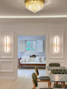 a living room with a bed with a window at Armata Boutique Hotel in Spetses
