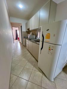 a kitchen with a white refrigerator in a room at Dep 7 Zona Cardiológico Centro in Corrientes +8 photos