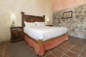 A bed or beds in a room at Collection O Cachito Mio