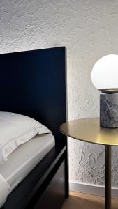 a bedroom with a bed and a table at EVA boutique apartments in Vilnius
