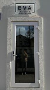 a person taking a picture of a mirror in a door at EVA boutique apartments in Vilnius