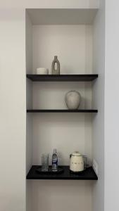 a shelf with bowls and other items on it at EVA boutique apartments in Vilnius