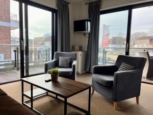 a living room with two chairs and a coffee table at Appartementhaus Seemöwe Grasmöwe in Grömitz