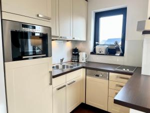 Η κουζίνα ή μικρή κουζίνα στο Appartementhaus Seemöwe Korallenmöwe +6 φωτογραφίες