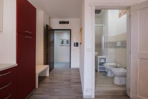 y baño con 2 aseos, bañera y lavamanos. en BED INN - Palazzo Urbe, en Olbia