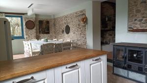 a kitchen with a table and a dining room at La Chouette in Pieve di Teco