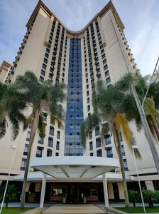 a building with palm trees in front of it at Suíte Luxo Congonhas com sofá cama (Apto 2005H) in Sao Paulo