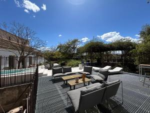 a patio with couches and a table and a fence at Amazing suite by the fair in Valencia