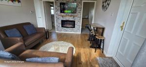 a living room with a couch and a fireplace at Cozy Nook in Gristhorpe
