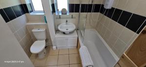 a small bathroom with a toilet and a sink at Cozy Nook in Gristhorpe +13 photos
