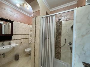 a bathroom with a shower and a sink and a toilet at Da Pupa, apartment with a sea view in Vico Equense +2 photos