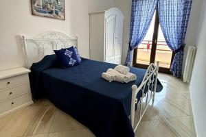 a bedroom with a bed with two towels on it at Da Pupa, apartment with a sea view in Vico Equense