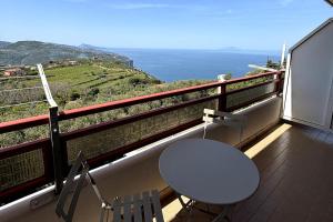 a table and chairs on a balcony with a view at Da Pupa, apartment with a sea view in Vico Equense