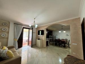a living room with a couch and a dining room at Da Pupa, apartment with a sea view in Vico Equense