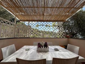 a table with a white table cloth on a patio at Da Pupa, apartment with a sea view in Vico Equense