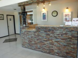 a brick counter with a clock on a wall at America's Best Inn & Suites-Lakeland in Lakeland