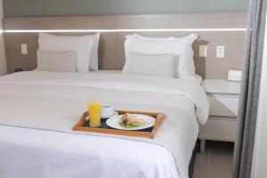 Postel nebo postele na pokoji v ubytování Hotel Adrianópolis All Suites