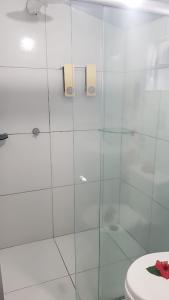 a bathroom with a glass shower with a toilet at Pousada Capim Açu in Fernando de Noronha +73 photos