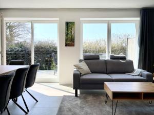 a living room with a couch and a table at Am Dahmer Leuchtturm 23f in Dahme