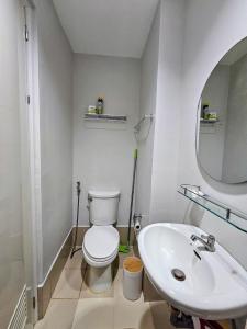 a bathroom with a white toilet and a sink at The Loop 2204 - Goff's Place in Cagayan de Oro