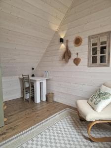 a room with a table and a chair in a attic at Otwarte Okiennice Soce 74 in Soce