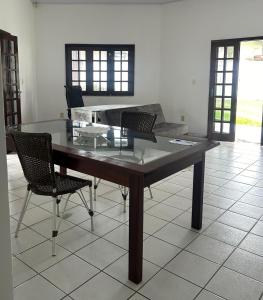 a dining room table with chairs and a couch at Casa Araçagy in São-José-do-Ribamar