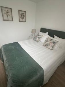 a bed with two pillows on it in a bedroom at Refúgio da Serra in Porto de Mós