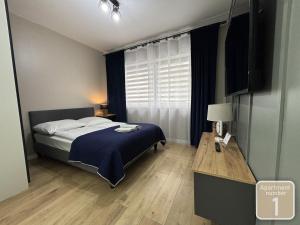 Posteľ alebo postele v izbe v ubytovaní Apartamenty Przy Deptaku w Radomiu
